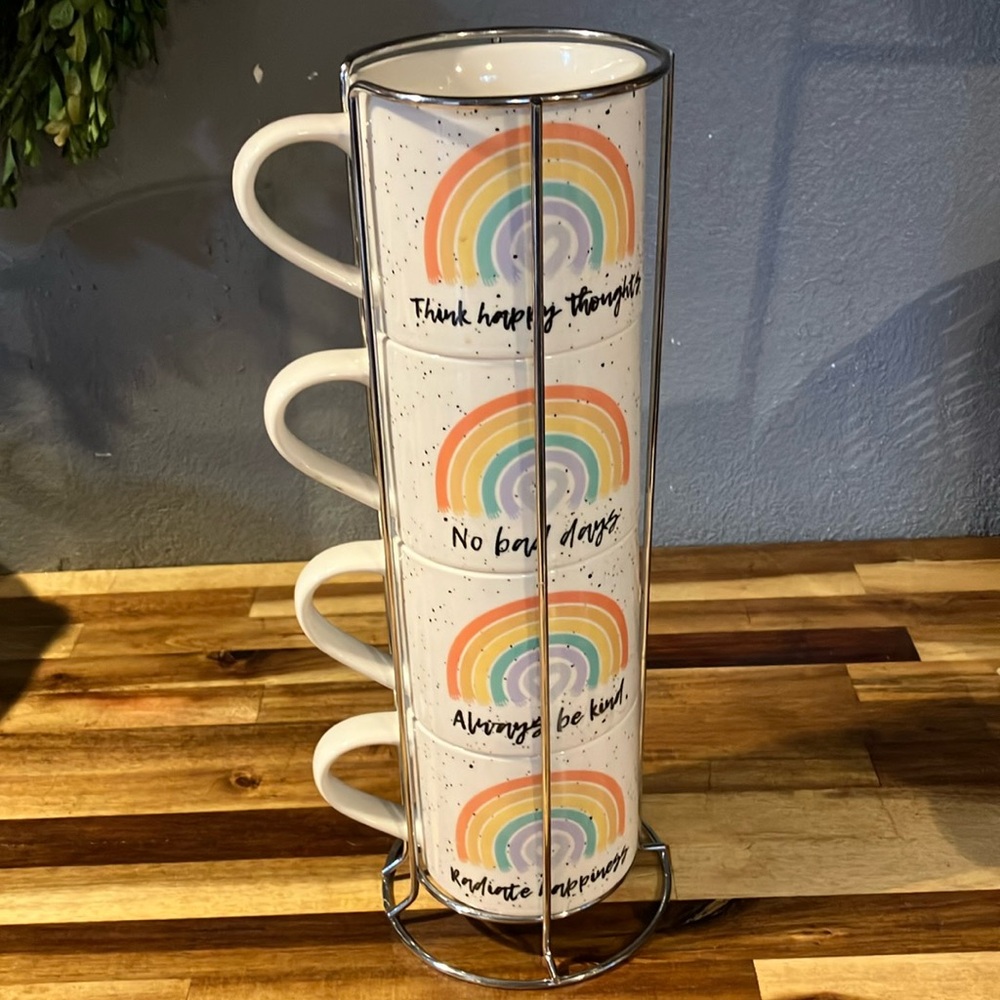 Set of 4 Coco and Lola coffee mugs in wire rack.